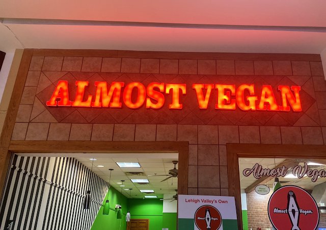 Almost Vegan Pescatarian Cafe logo